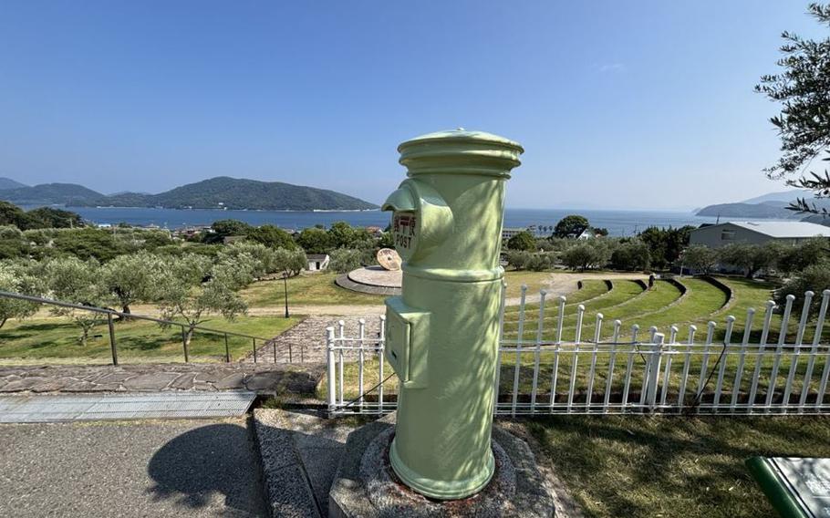 A light green mail box at Olive Park